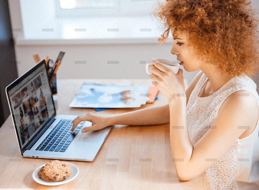 woman-photographer-drinking-coffee-and-working-PJNBP6U.jpg